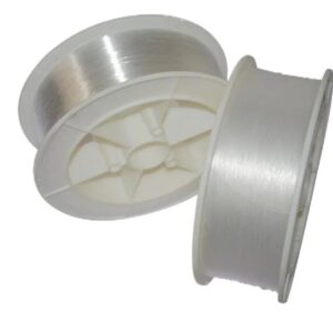 A close-up view of two white plastic reels holding clear, thin strands of end-glow plastic optical fiber, demonstrating the material used to create starlight ceilings.